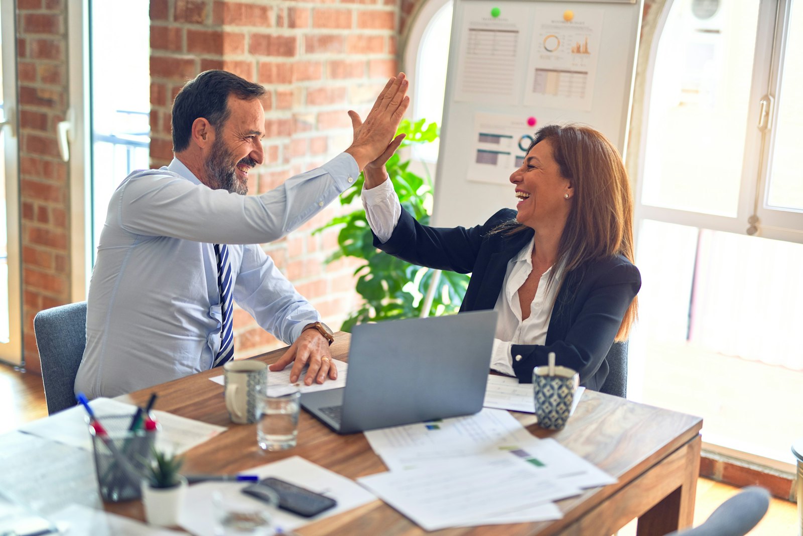 Two people celebrating a successful trade